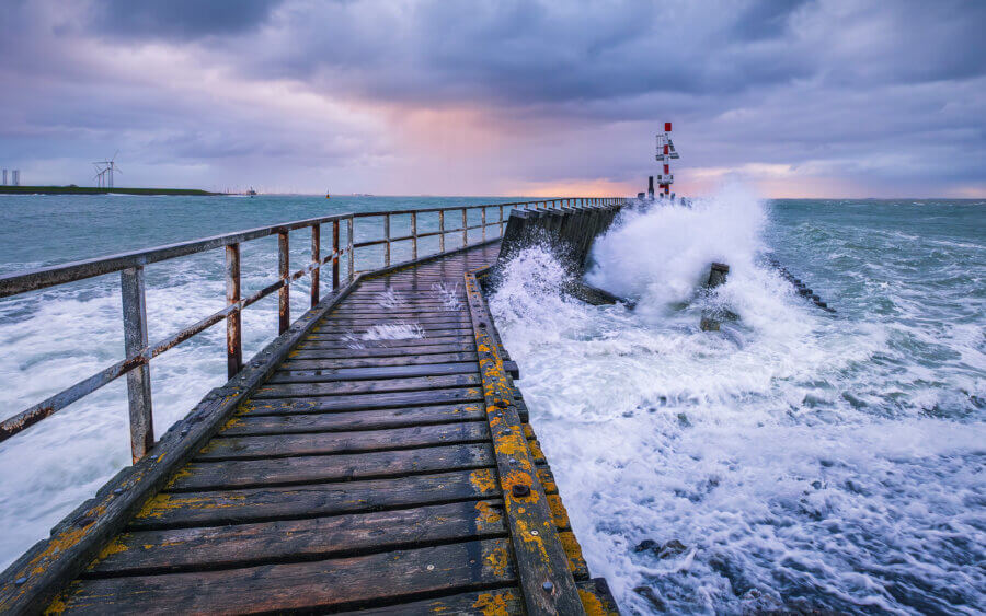 Vlissingen Met windkracht 7 aan de Westerschelde in Vlissingen. De golven breken zich kapot op de steiger tijdens zonsopkomst.